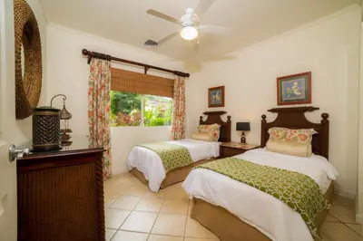 a bedroom with two beds and a ceiling fan at Del Mar 3N 3 bdr Garden View in Los Suenos in Herradura