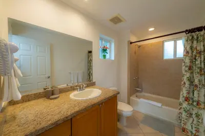 a bathroom with a sink and a toilet and a tub at Del Mar 4G 3 bdr Garden View in Los Suenos in Herradura