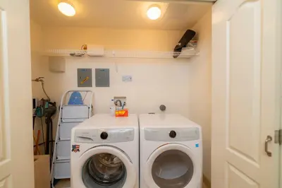 a laundry room with a washing machine and a washer at Del Mar 4G 3 bdr Garden View in Los Suenos in Herradura