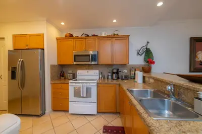 a kitchen with a refrigerator and a sink at Del Mar 4G 3 bdr Garden View in Los Suenos in Herradura