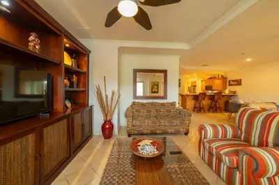 a living room with a couch and a tv at Del Mar 4O 2 bdr Garden View in Los Suenos in Herradura