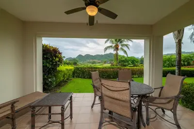 a patio with a table and chairs and a ceiling fan at Del Mar 4O 2 bdr Garden View in Los Suenos in Herradura