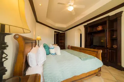 a bedroom with a bed with a ceiling fan at Marbella 2A 3 bdr Ocean View in Los Suenos in Herradura