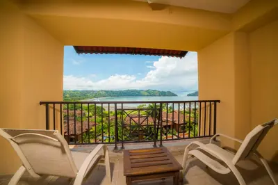 a balcony with chairs and a view of the ocean at Marbella 2A 3 bdr Ocean View in Los Suenos in Herradura