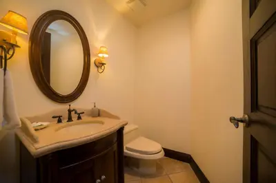 a bathroom with a sink and a toilet and a mirror at Marbella 2A 3 bdr Ocean View in Los Suenos in Herradura