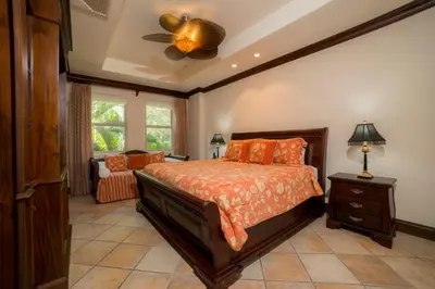 a bedroom with a bed and a ceiling fan at Marbella 3D 3 bdr Ocean View in Los Suenos in Herradura
