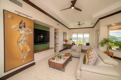 a living room with a large painting of a woman at Terrazas 1A 3 bdr Ocean View in Los Suenos in Herradura