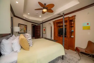 a bedroom with a bed and a ceiling fan at Terrazas 1A 3 bdr Ocean View in Los Suenos in Herradura