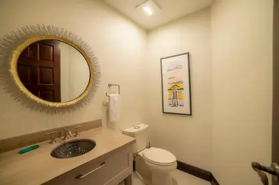 a bathroom with a sink and a toilet and a mirror at Terrazas 1A 3 bdr Ocean View in Los Suenos in Herradura