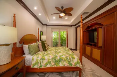a bedroom with a bed and a flat screen tv at Terrazas 1A 3 bdr Ocean View in Los Suenos in Herradura
