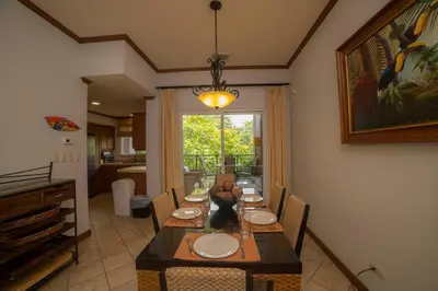 a dining room with a long table and chairs at Veranda 2B 3 bdr Golf Course View in Los Suenos in Herradura