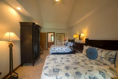 a bedroom with two beds and a lamp at Veranda 2B 3 bdr Golf Course View in Los Suenos in Herradura