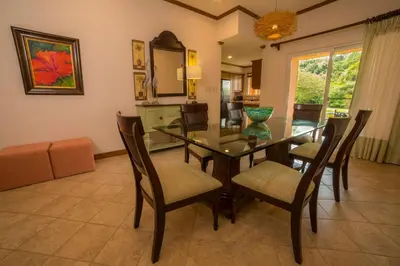 a dining room with a table and chairs at Veranda 8F 2 bdr Garden View in Los Suenos in Herradura