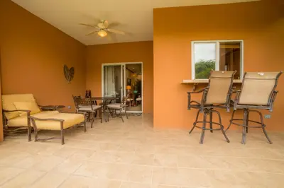 a living room with chairs and a table at Veranda 8F 2 bdr Garden View in Los Suenos in Herradura
