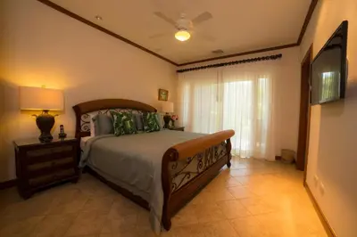 a bedroom with a bed and a ceiling fan at Veranda 8F 2 bdr Garden View in Los Suenos in Herradura
