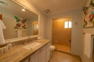 a bathroom with a sink and a toilet and a shower at Veranda 4B 3 bdr Golf Course View in Los Suenos in Herradura