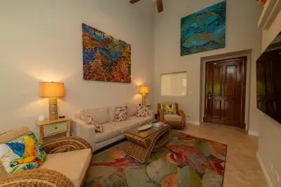 a living room with a couch and a table at Veranda 4B 3 bdr Golf Course View in Los Suenos in Herradura