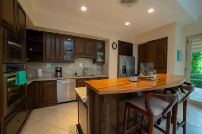 a kitchen with wooden cabinets and a wooden counter top at Bella Vista 3F 3 bdr beach club view in Los Suenos in Herradura
