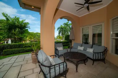 a patio with chairs and a couch and a table at Bella Vista 3F 3 bdr beach club view in Los Suenos in Herradura