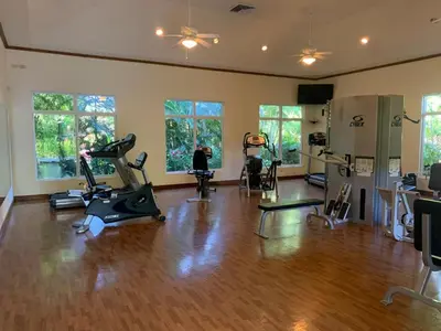 a gym with treadmills and exercise bikes in a room at Bella Vista 3F 3 bdr beach club view in Los Suenos in Herradura
