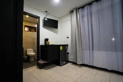 a bathroom with a toilet and a shower curtain at La Casona in Fortuna