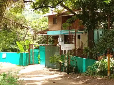 a house with a green gate in front of it at J Bay : Burnt Toast Surfcamp in Nosara
