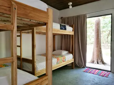 two bunk beds in a room with a window at Zeneidas Surf Garden in Santa Teresa Beach