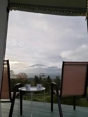 a table and chairs with a view of a mountain at Finca Tres Equis - Farm and Forest in Tres Equis