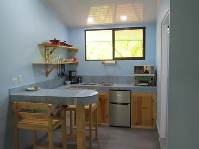 a kitchen with a counter and a sink and a window at Peace of Paradise Breakfast Included Free Manuel Antonio Park Tour in Manuel Antonio