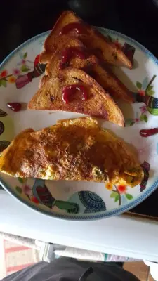 two pieces of toast on a plate with ketchup at Corredores del Pacuare in La Suiza