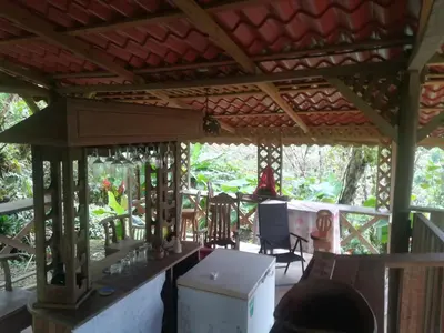 a porch of a house with a table and chairs at Corredores del Pacuare in La Suiza