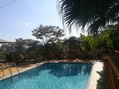 a swimming pool in front of a resort at Corredores del Pacuare in La Suiza