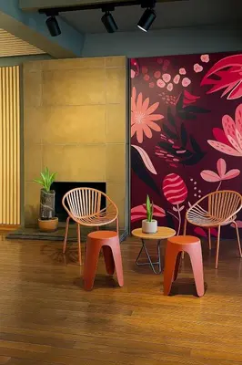 a room with three chairs and a flower mural at awā San José in San José