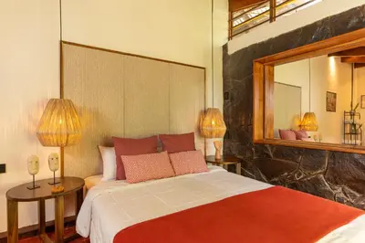 a bedroom with a bed and a large mirror at awā San José in San José