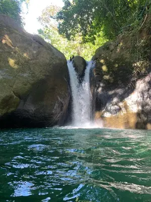 a waterfall in the middle of a body of water at The Scarlet Villas in Ojochal