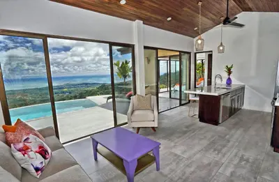 a kitchen and living room with a view of the ocean at Golden Pineapple Villas-Adults Only in Uvita
