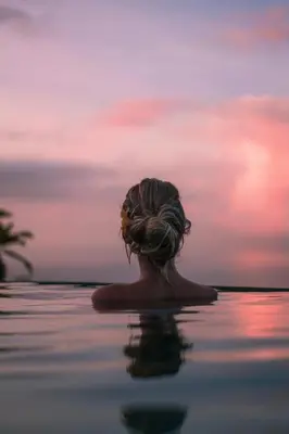 a woman in the water at sunset at Golden Pineapple Villas-Adults Only in Uvita