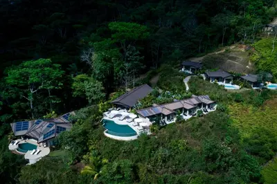 an aerial view of a house with a boat on a hill at Golden Pineapple Villas-Adults Only in Uvita