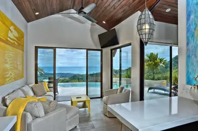 a living room with a couch and a table at Golden Pineapple Villas-Adults Only in Uvita