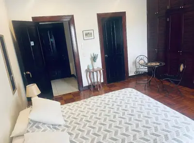 a bedroom with a bed and a table and chairs at Ester`s Place in Escazu