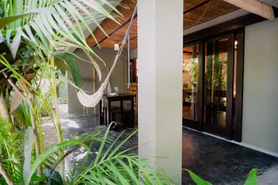 a room with a hammock in a house with plants at Lua Villas in Santa Teresa Beach