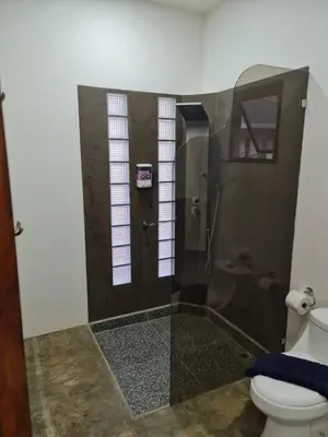 a bathroom with a shower and a toilet at Buddha Retreat Hotel in San Juanillo