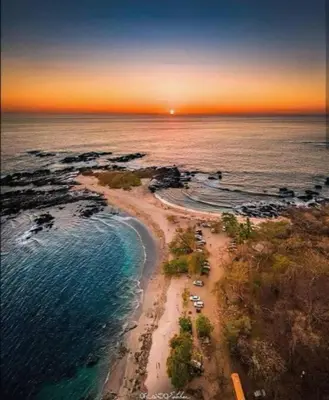 an aerial view of a beach at sunset at Buddha Retreat Hotel in San Juanillo