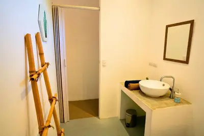 a bathroom with a sink and a mirror on a counter at Antema Lodge Secteur Tamarindo, piscine, yoga, gym, jungle et paix in Tamarindo