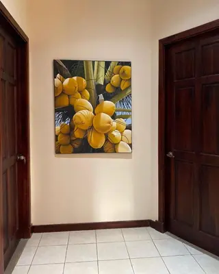 a painting of fruit hanging on a wall at Palm Coast Luxury Rentals in Esterillos Este