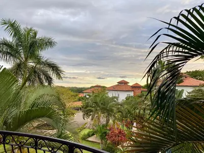 a view of a resort with palm trees and a river at Palm Coast Luxury Rentals in Esterillos Este