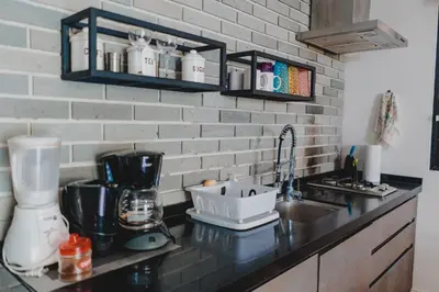 a kitchen with a sink and a counter with a mixer at Peace Lofts and Apartments in Santa Teresa Beach