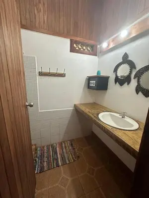 a bathroom with a sink and a counter top at Hotel Don Quichotte in Tortuguero