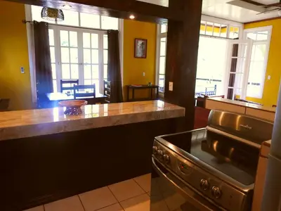 a kitchen with a stove and a counter top at Villas las Palmas in Fortuna