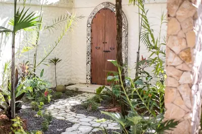a garden with a wooden door and some plants at Villas las Palmas in Fortuna